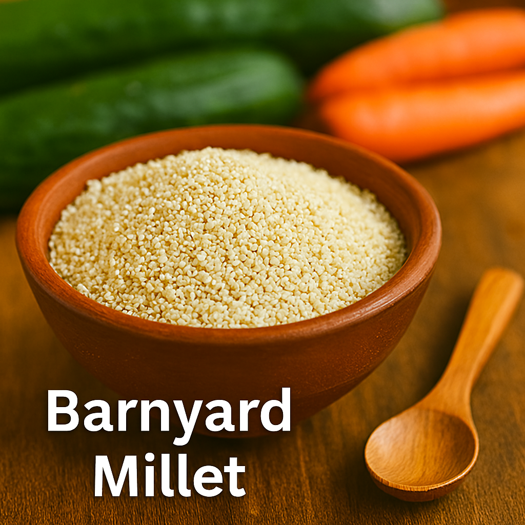 Close-up of barnyard millet grains in a rustic clay bowl on a wooden table, with a small wooden spoon beside it and fresh cucumbers and carrots in the background, softly lit by natural daylight.